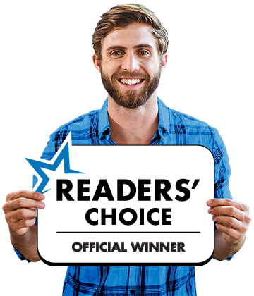 Happy store owner holding a Readers Choice Official Winner