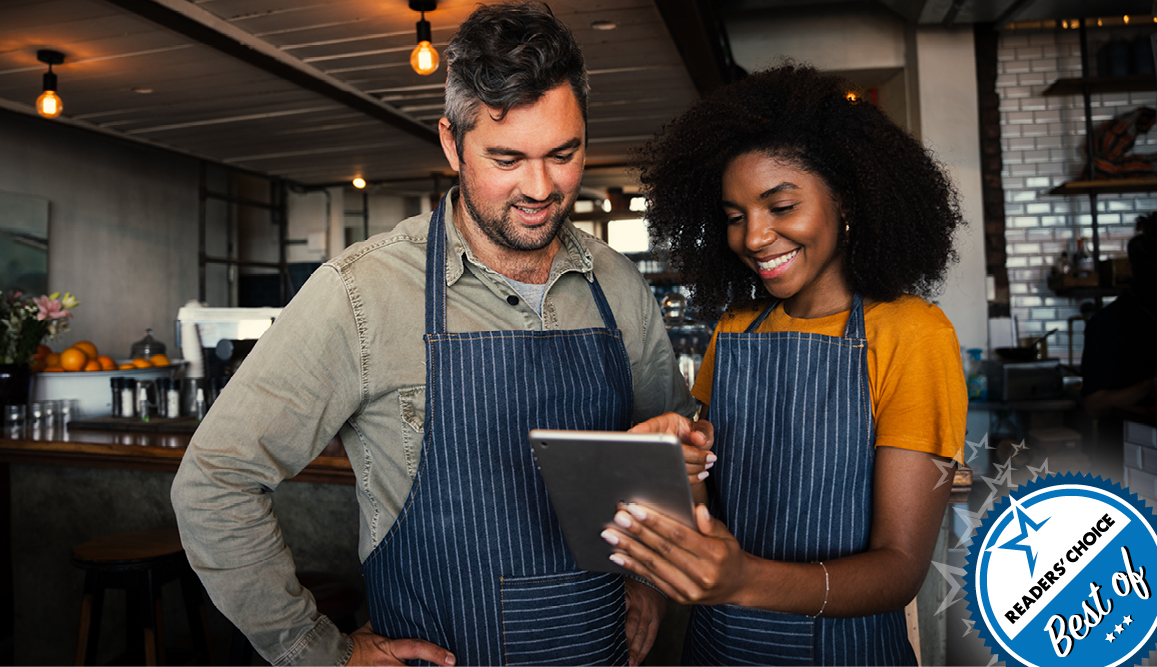 Image of two small business owners viewing an ipad.