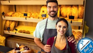 Couple standing at counter in their independent bakery.